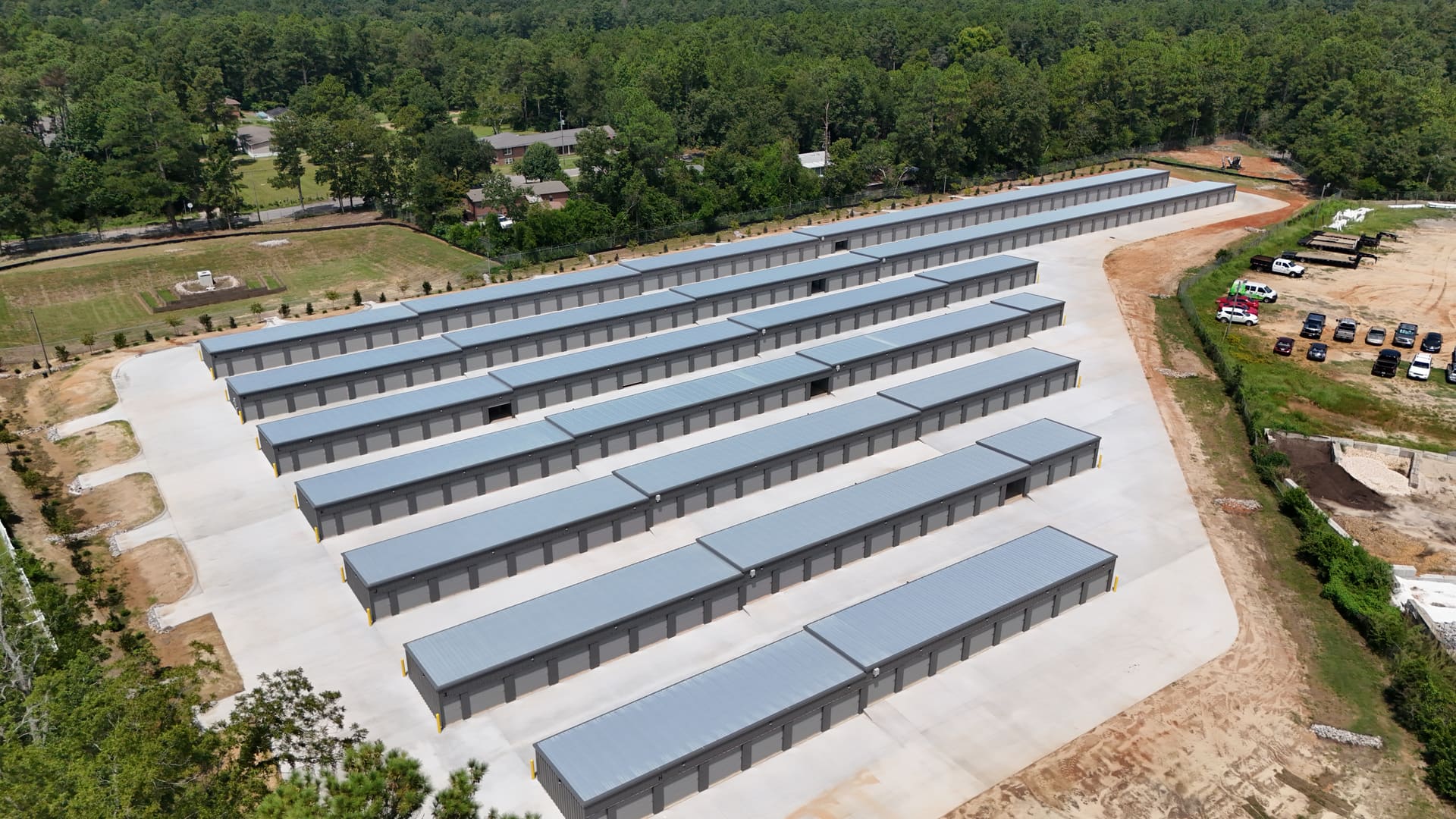 Aerial view looking down the length of My Storage's storage buildings, showing the wide concrete drive aisles between each row.